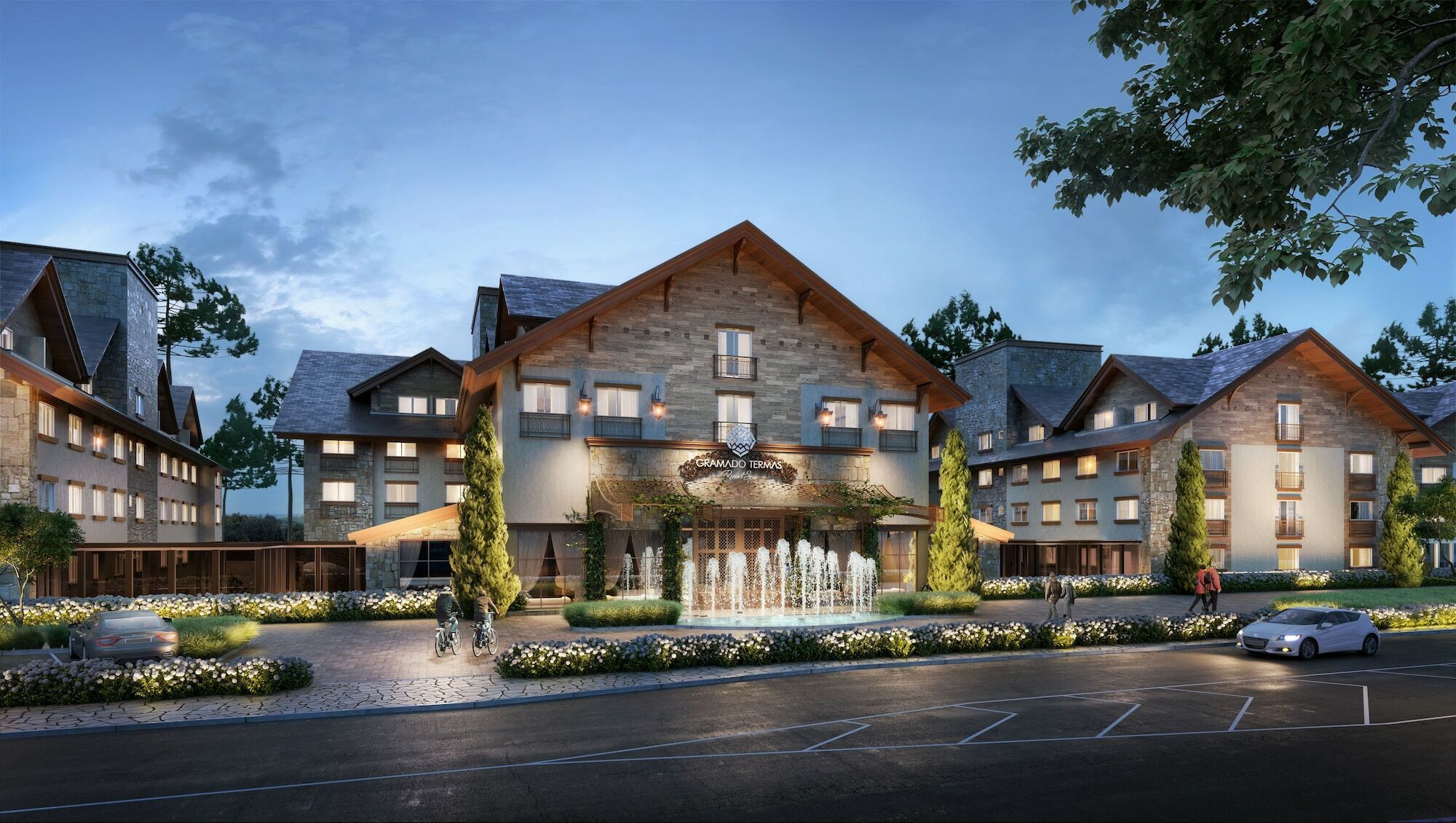 Wyndham Gramado Termas Resort & Spa Ngoại thất bức ảnh The image shows a beautiful lodge-style building, likely a hotel or resort. It features a sloped roof with wooden accents and large windows. In front of the building, there is a decorative fountain surrounded by landscaped greenery and flower beds. T